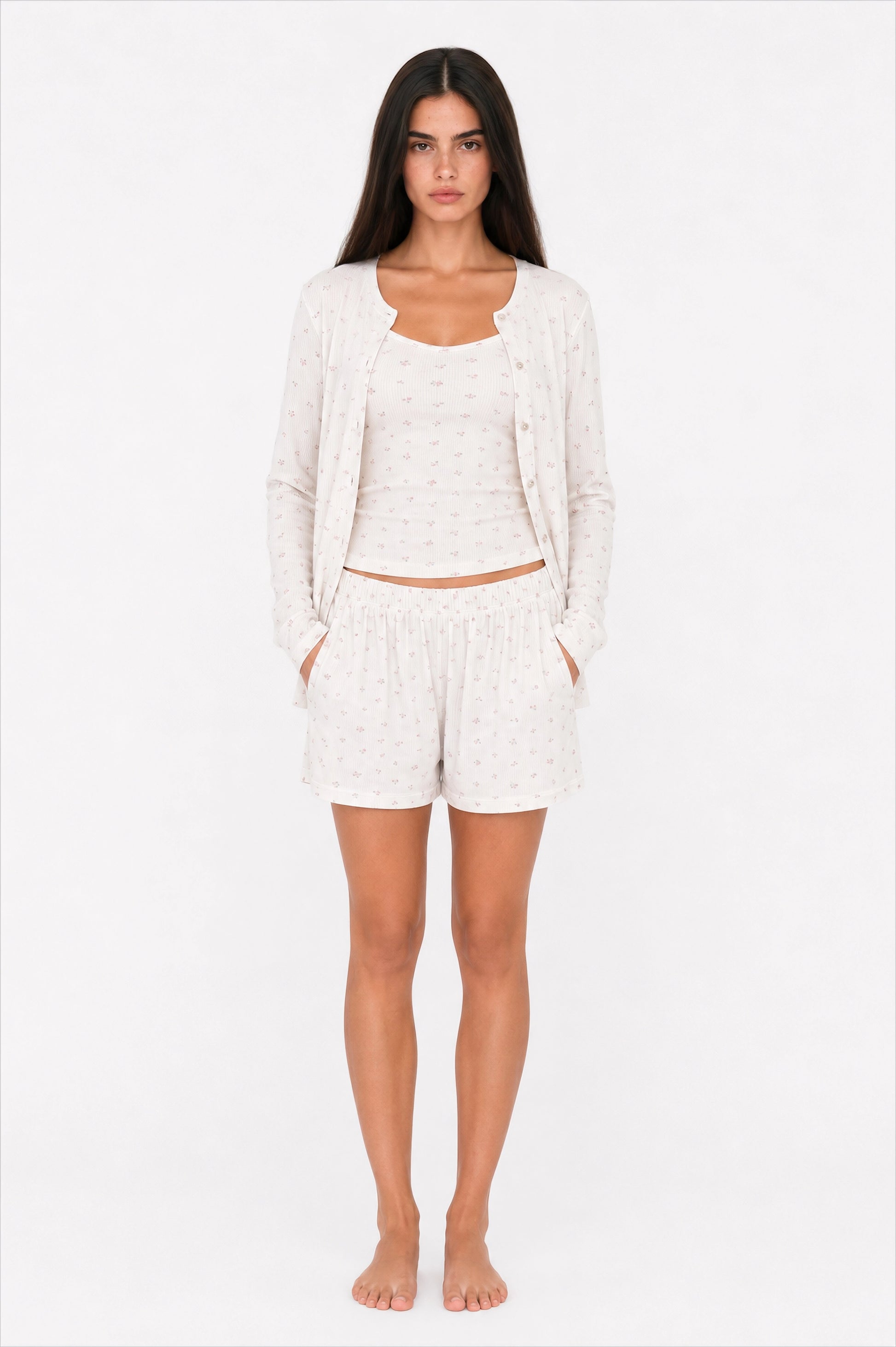 Woman wearing a white pajama set on a white background