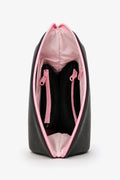 Black shoe bag with pink interior and zipper on a white background