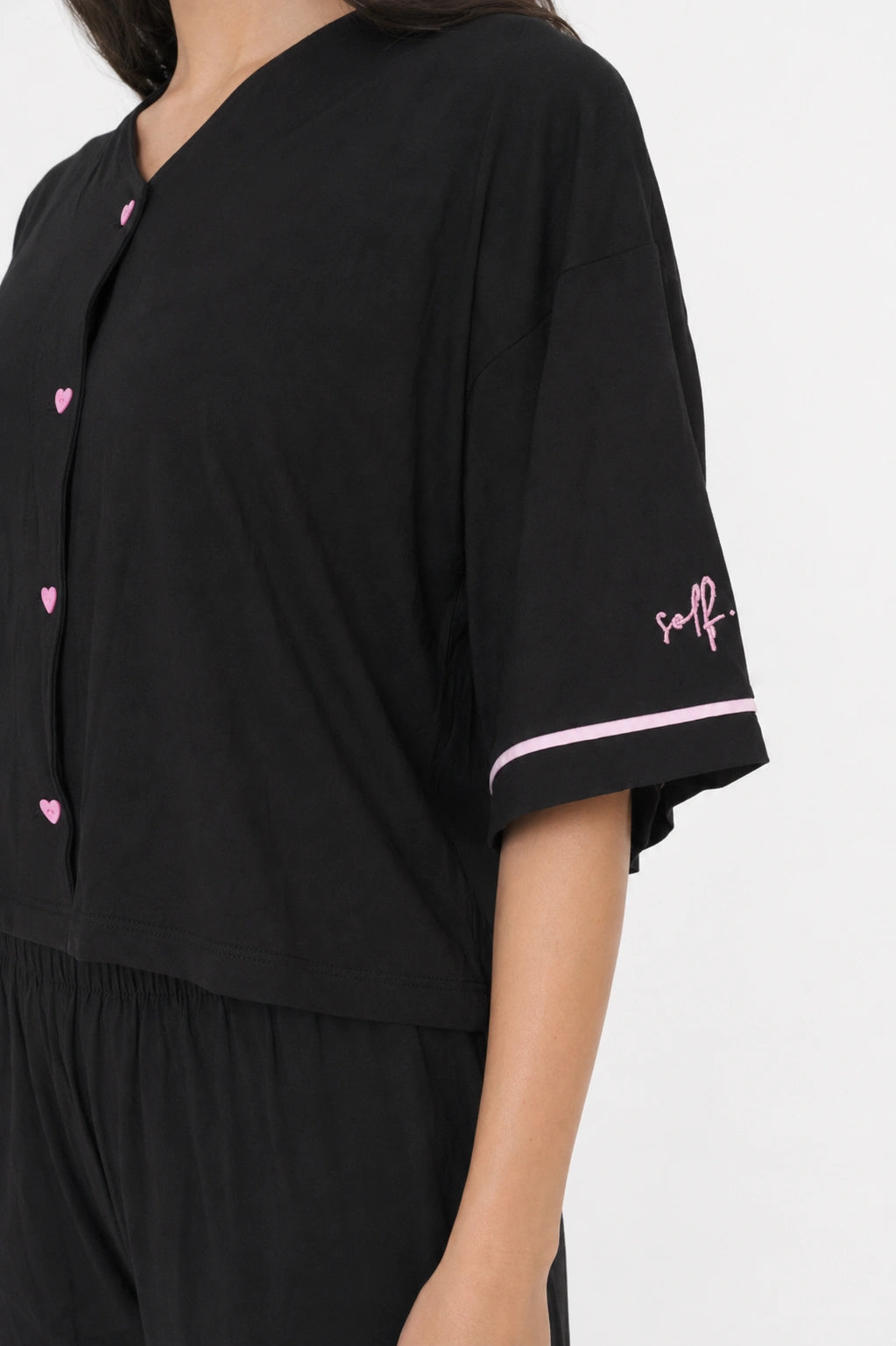 Black outfit with pink accents on a white background