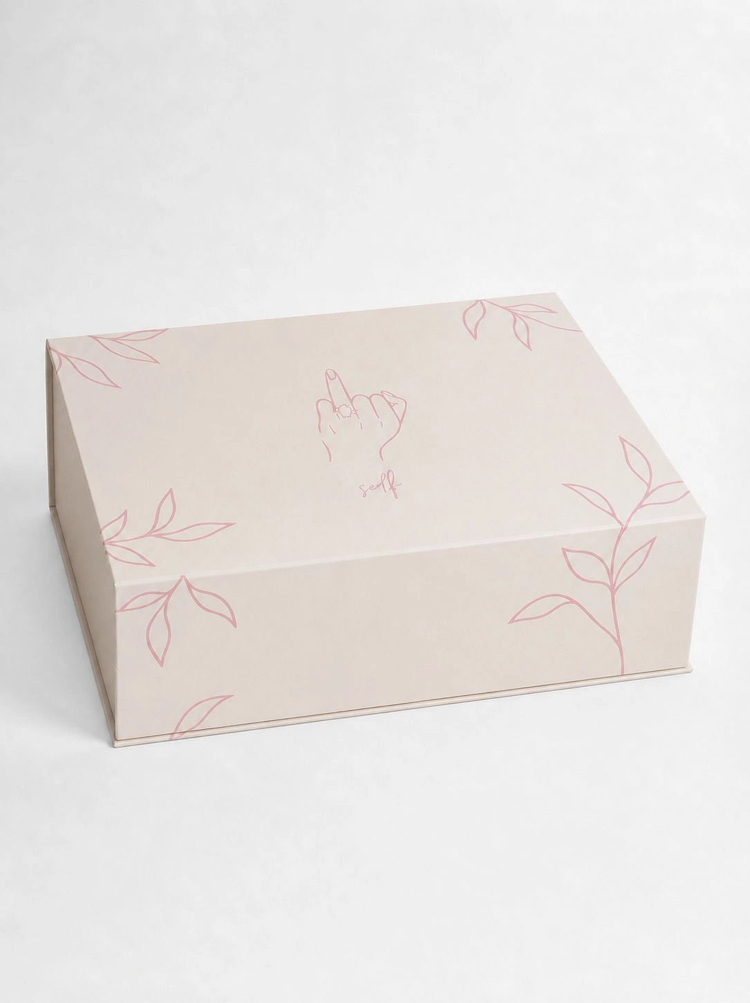 White box with floral patterns on a white fabric background