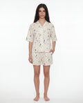 Woman wearing a floral pajama set on a white background