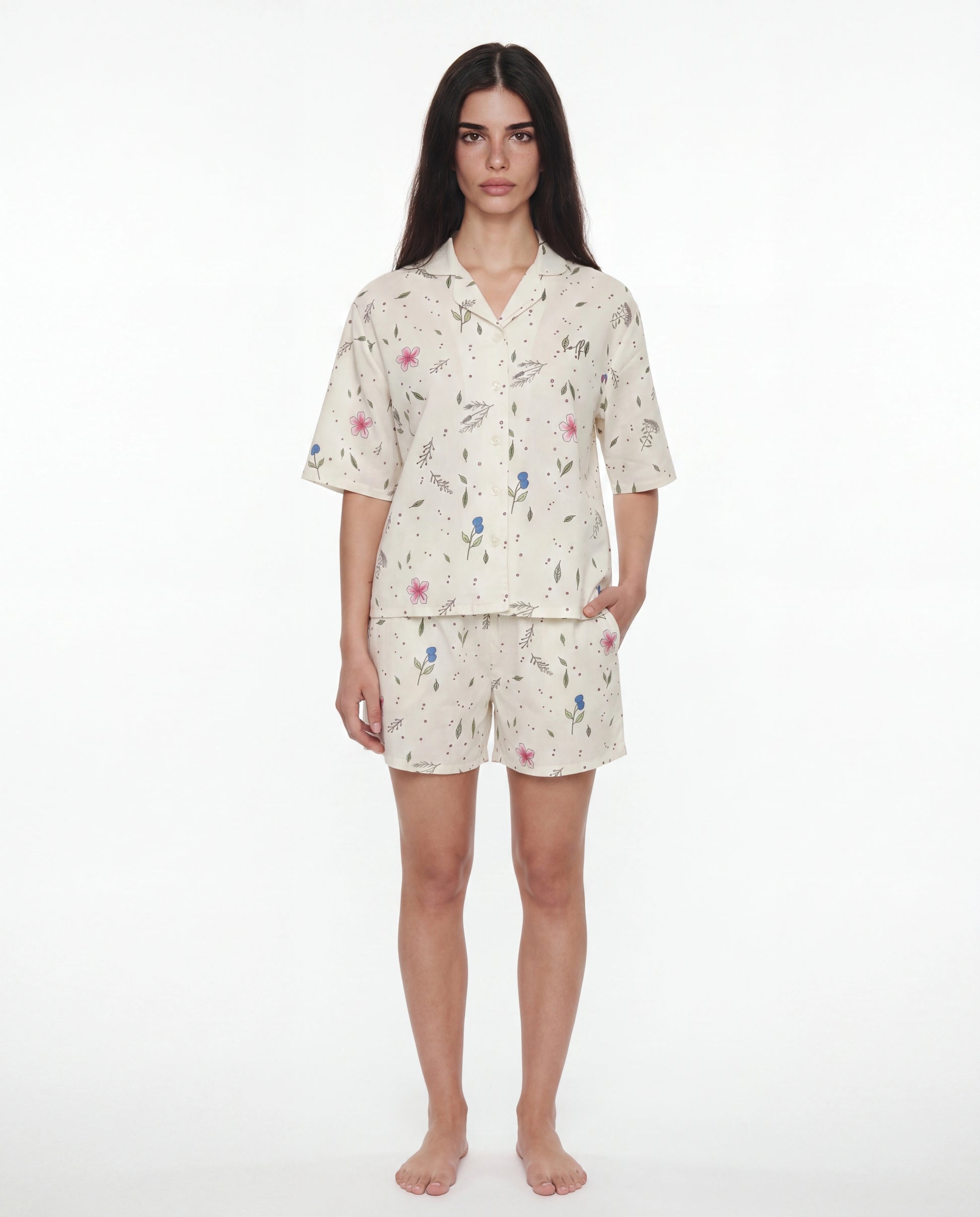 Woman wearing a floral pajama set on a white background
