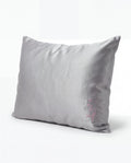 Gray pillow with a brand logo on a white background