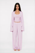 Woman wearing a lilac outfit on a white background