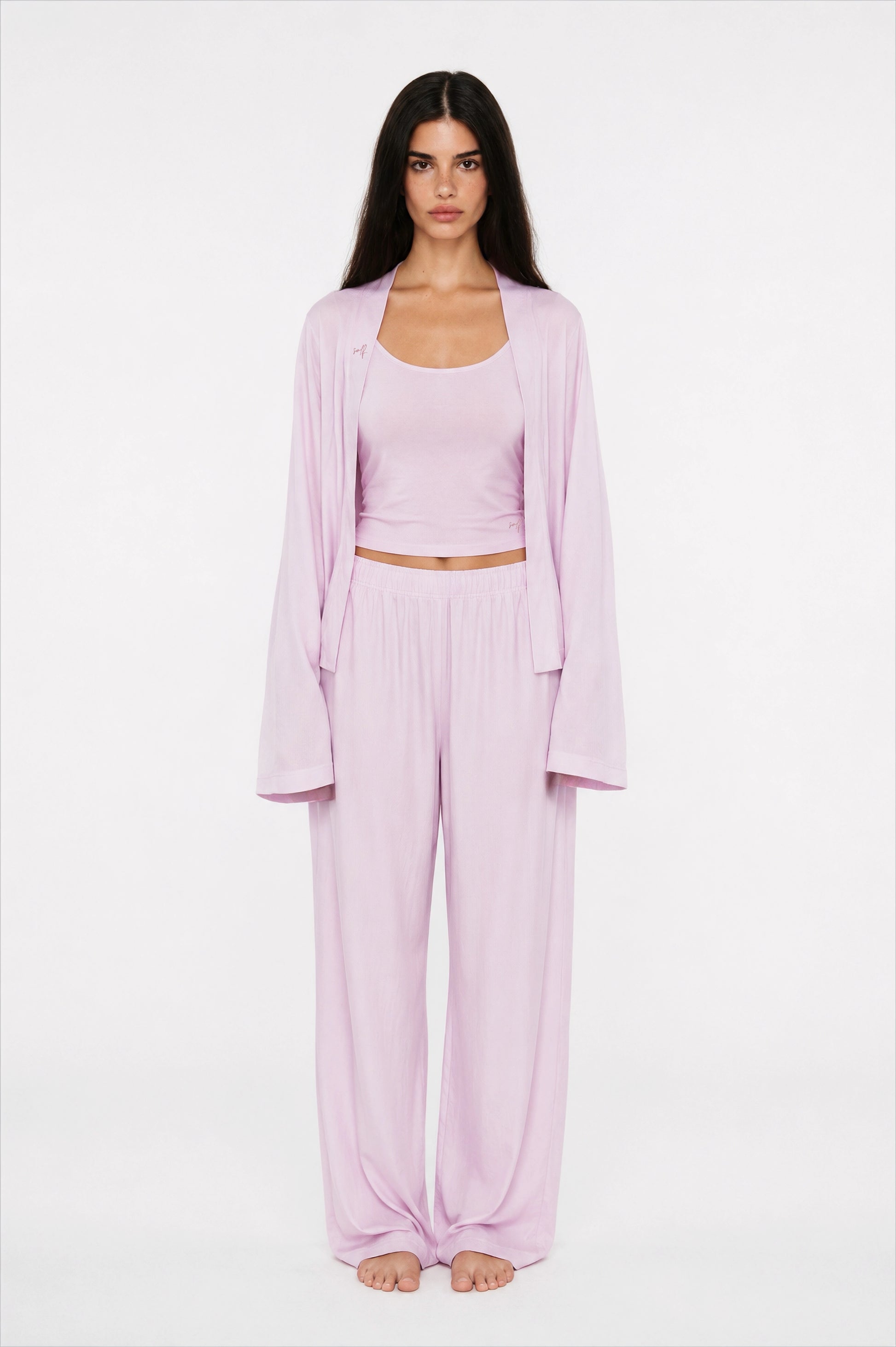 Woman wearing a lilac outfit on a white background