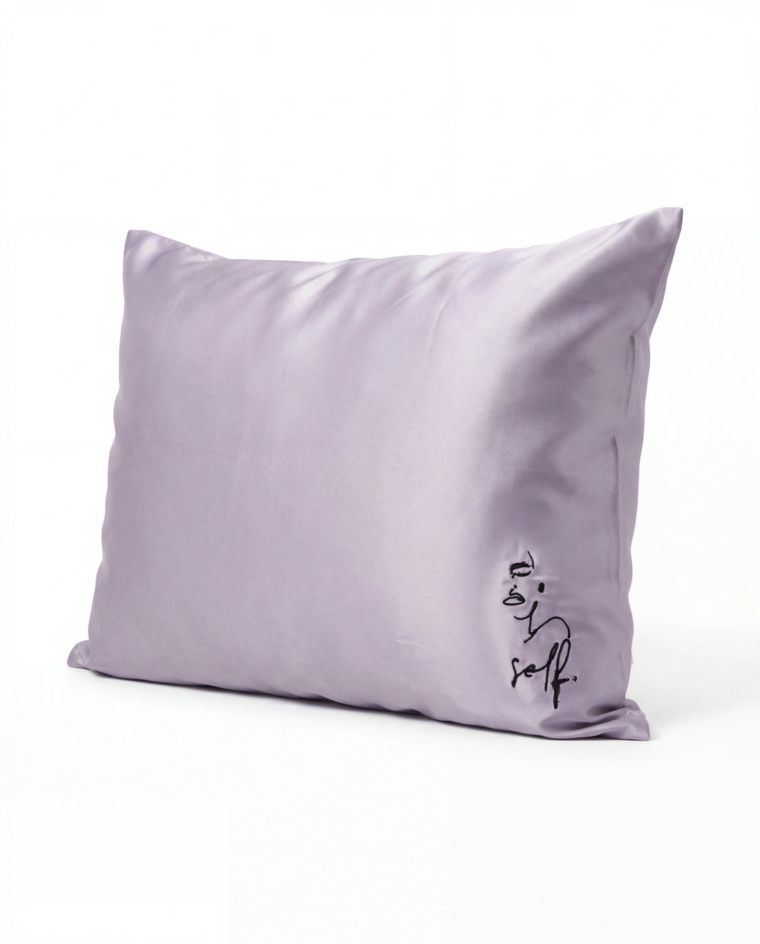 Lavender pillow with 'self' text on a white background
