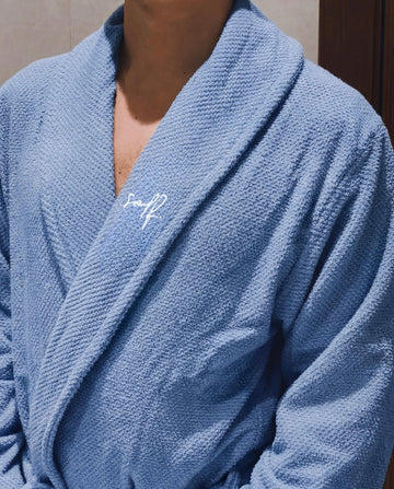Blue robe with a brand logo on a neutral background