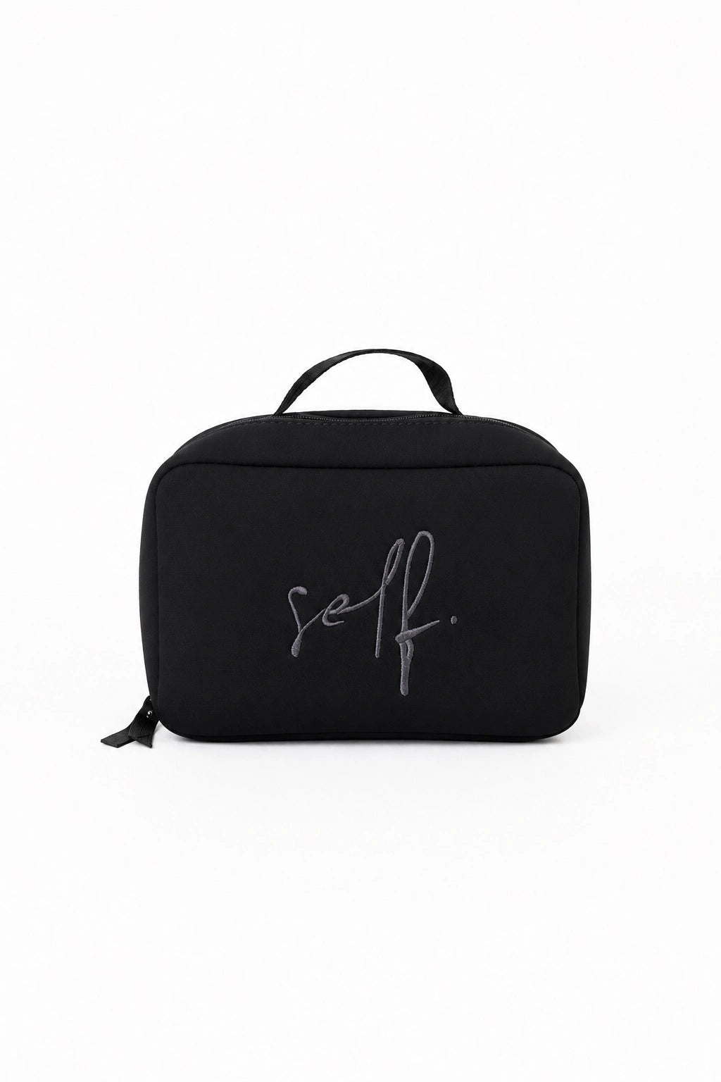 Black toiletry bag with 'self.' branding on a white background