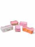 Five pink and peach-colored fabric packing cubes of various sizes arranged on a white background.