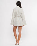 Woman wearing a floral robe on a white background