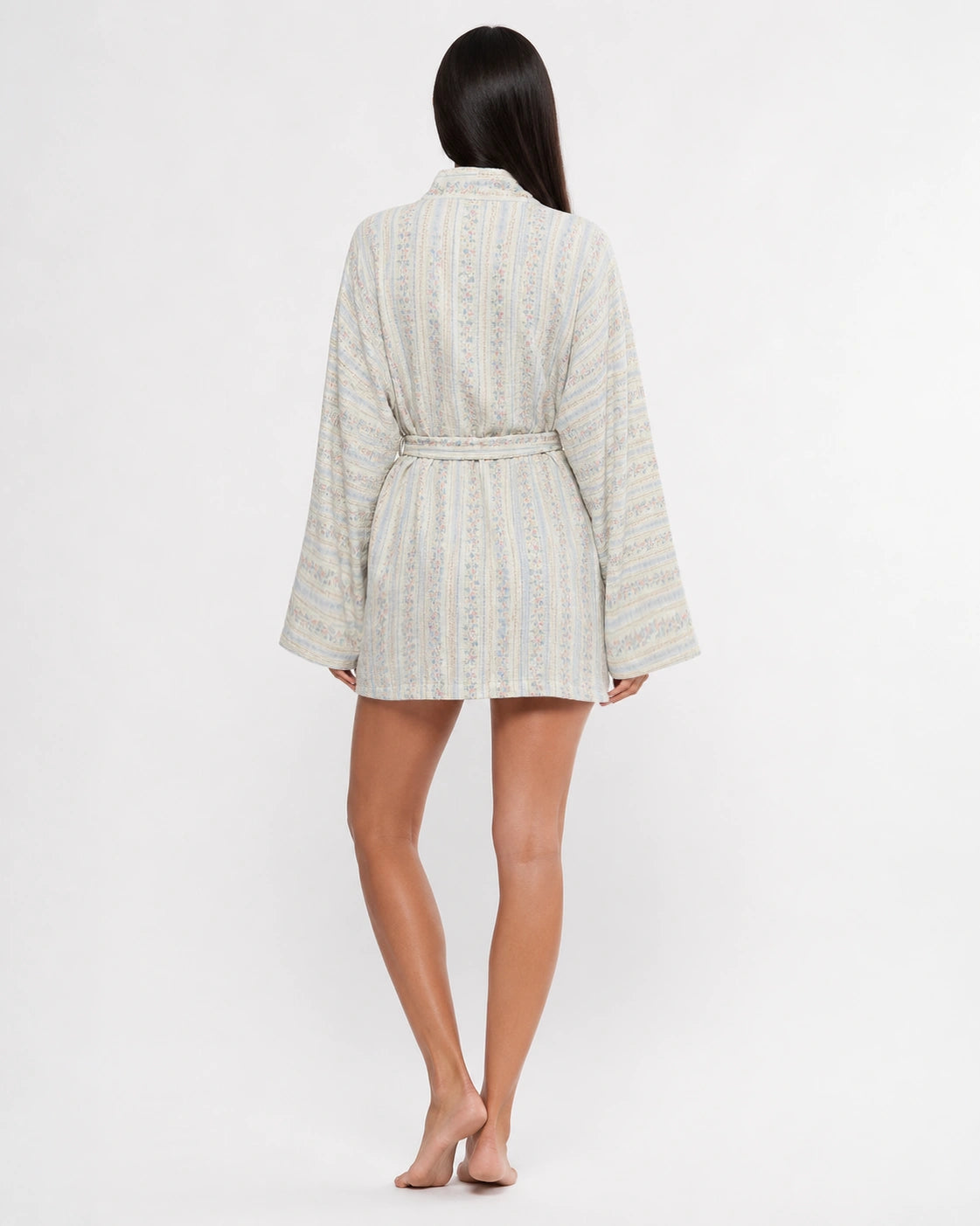 Woman wearing a floral robe on a white background