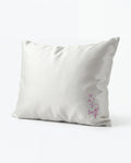 white pillow with a signature design on a white background
